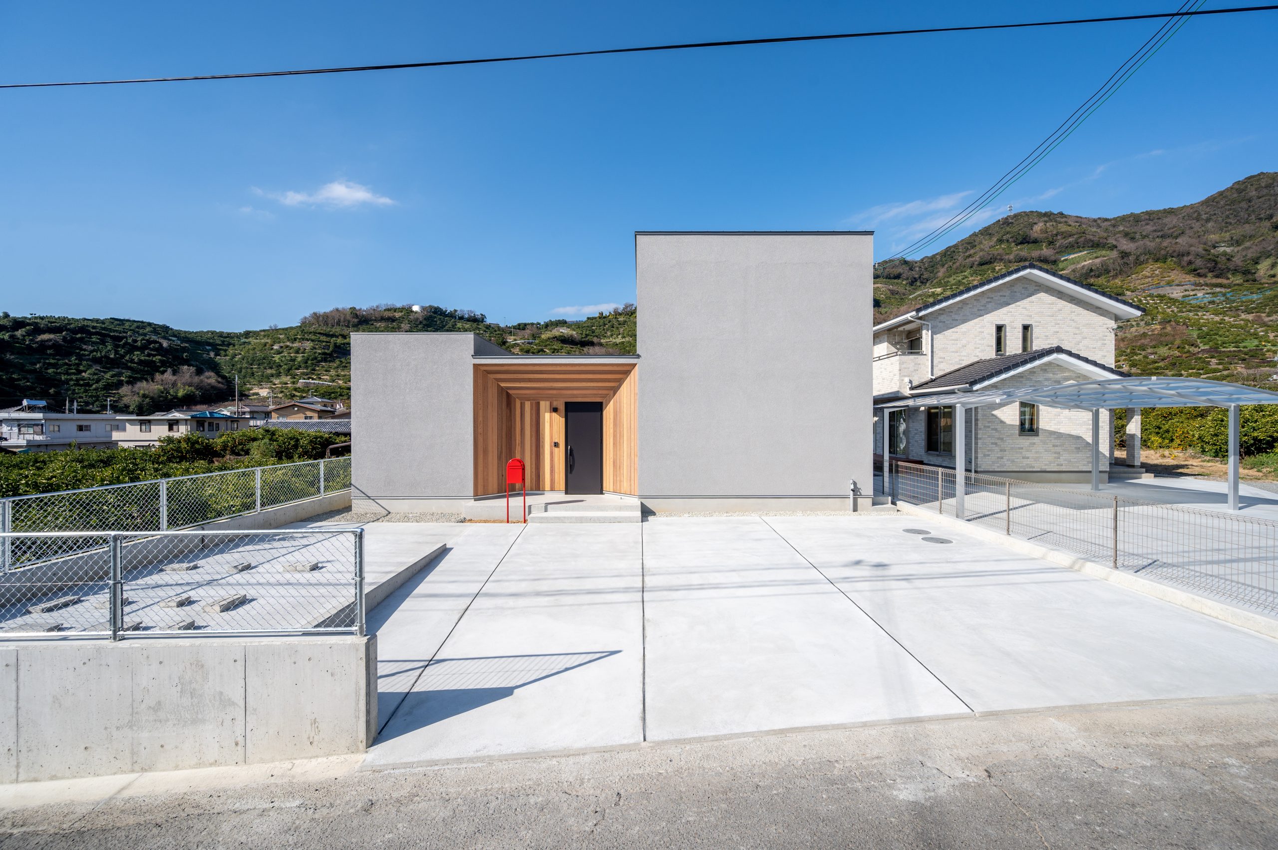 グレーの塗り壁×木目のモダンな住まい